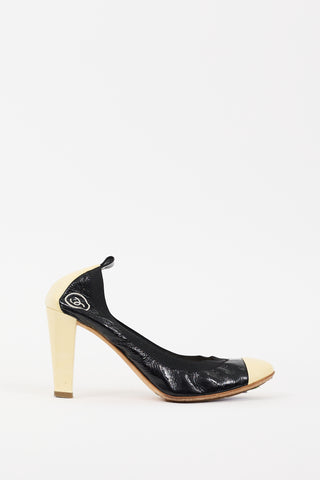 Chanel Black 
Cream Patent Leather CC Pump