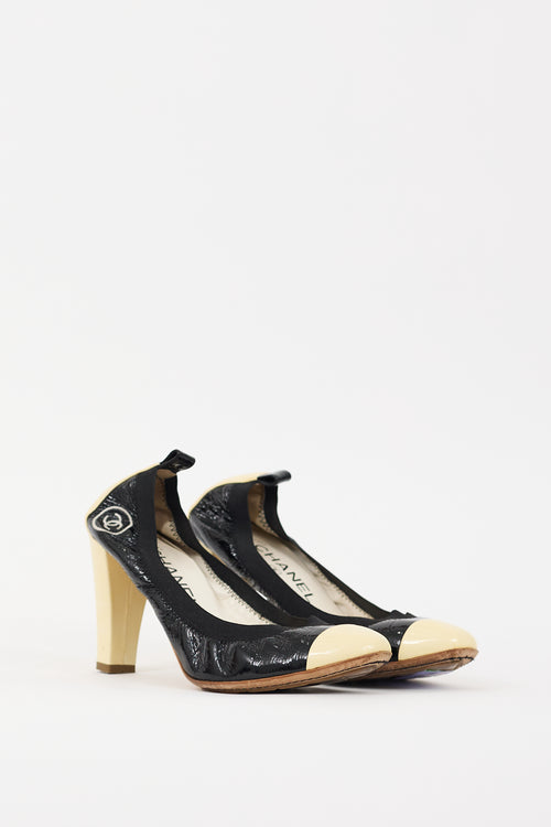 Chanel Black 
Cream Patent Leather CC Pump