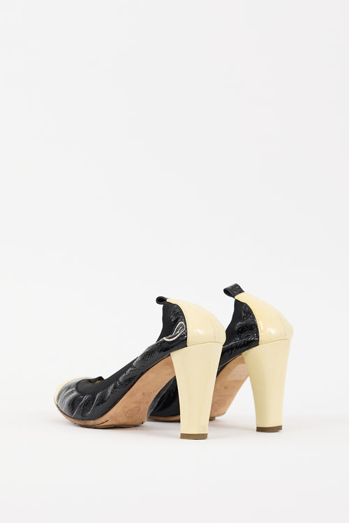 Chanel Black 
Cream Patent Leather CC Pump