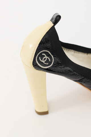 Chanel Black 
Cream Patent Leather CC Pump