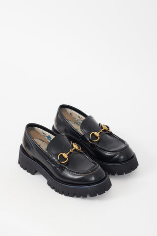 Gucci Black 
Gold Leather Embroidered Lug Sole Loafer