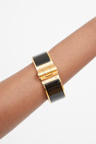 Hermès Black 
Gold Hinged Bracelet