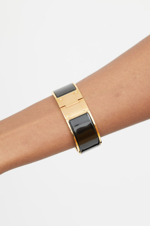 Hermès Black 
Gold Hinged Bracelet