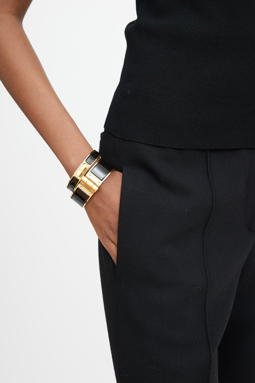 Hermès Black 
Gold Hinged Bracelet