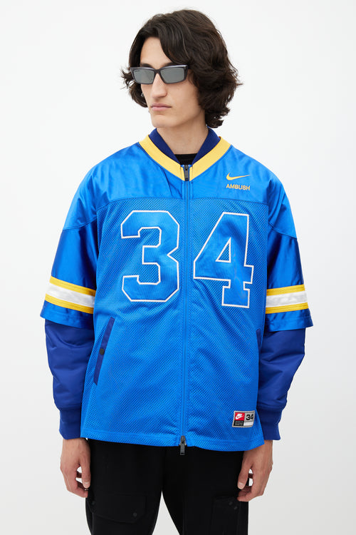 Nike x Ambush Blue 
Yellow Jersey Bomber Jacket