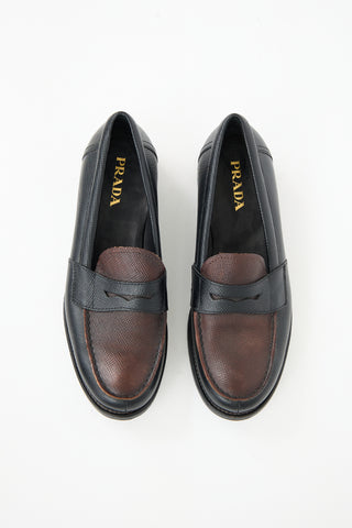 Prada Black 
Brown Textured Leather Penny Loafer