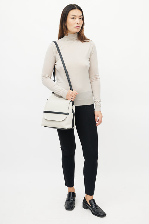 The Row Beige 
Black Canvas Sideby Bag