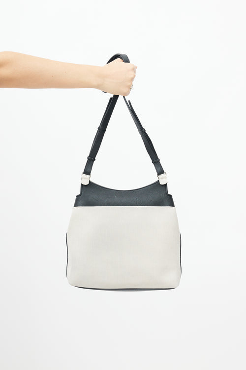 The Row Beige 
Black Canvas Sideby Bag