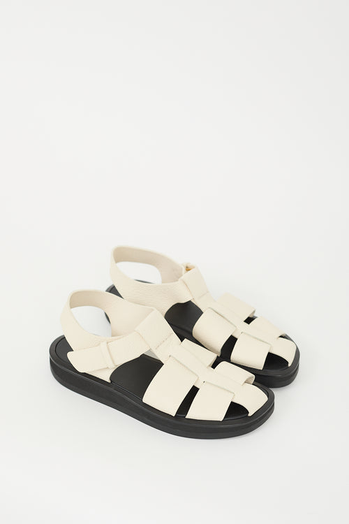 The Row Cream 
Black Leather Fisherman Sandal