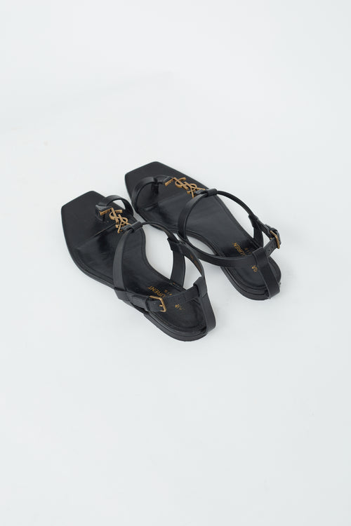 Saint Laurent Black Leather 
Gold Cassandra Flat Sandal