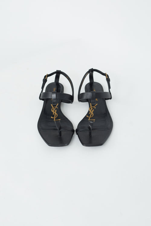 Saint Laurent Black Leather 
Gold Cassandra Flat Sandal