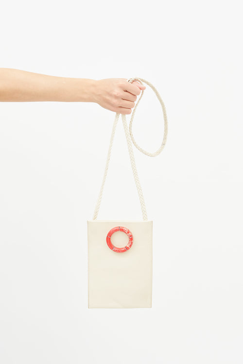 The Row Cream Leather 
Red Round Marble Medicine Pouch